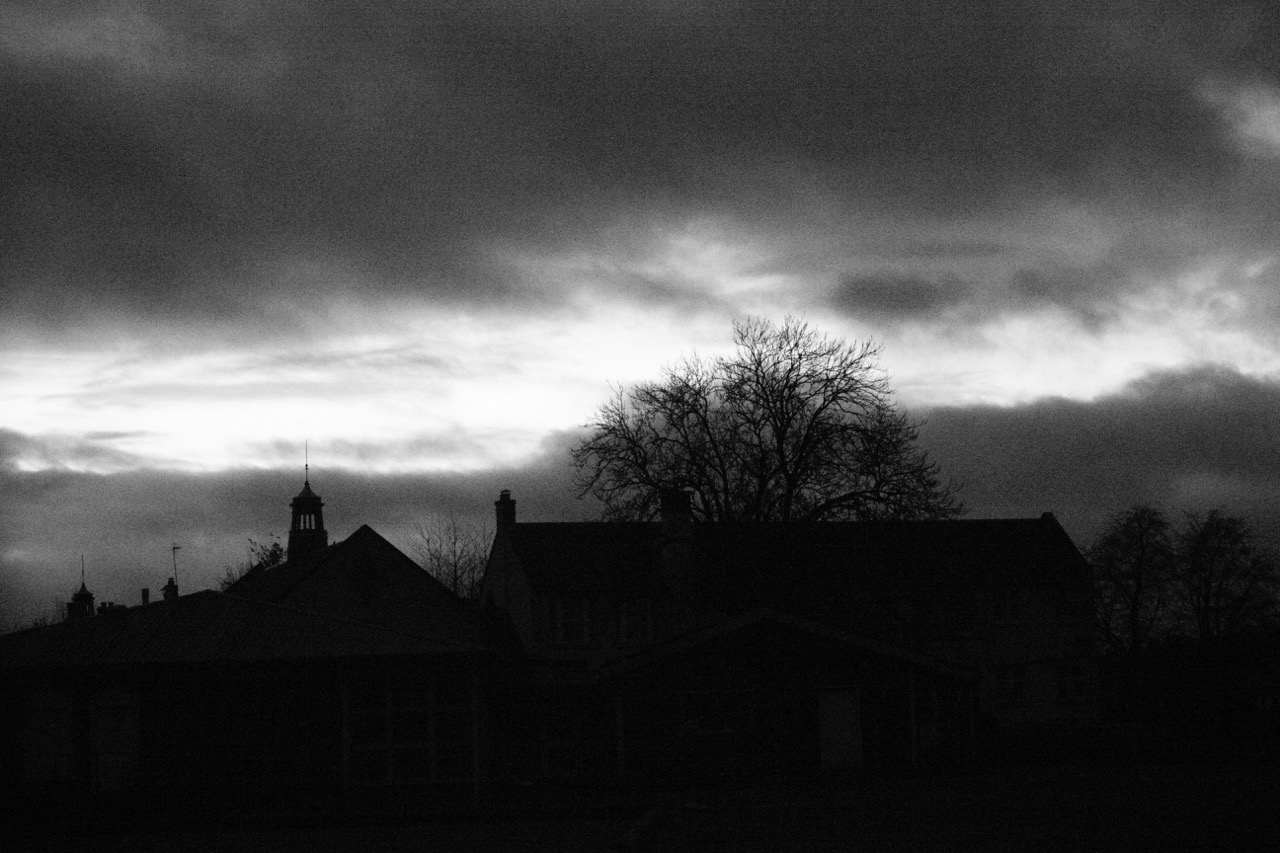 Buildings in Saughton backlit by a sunset